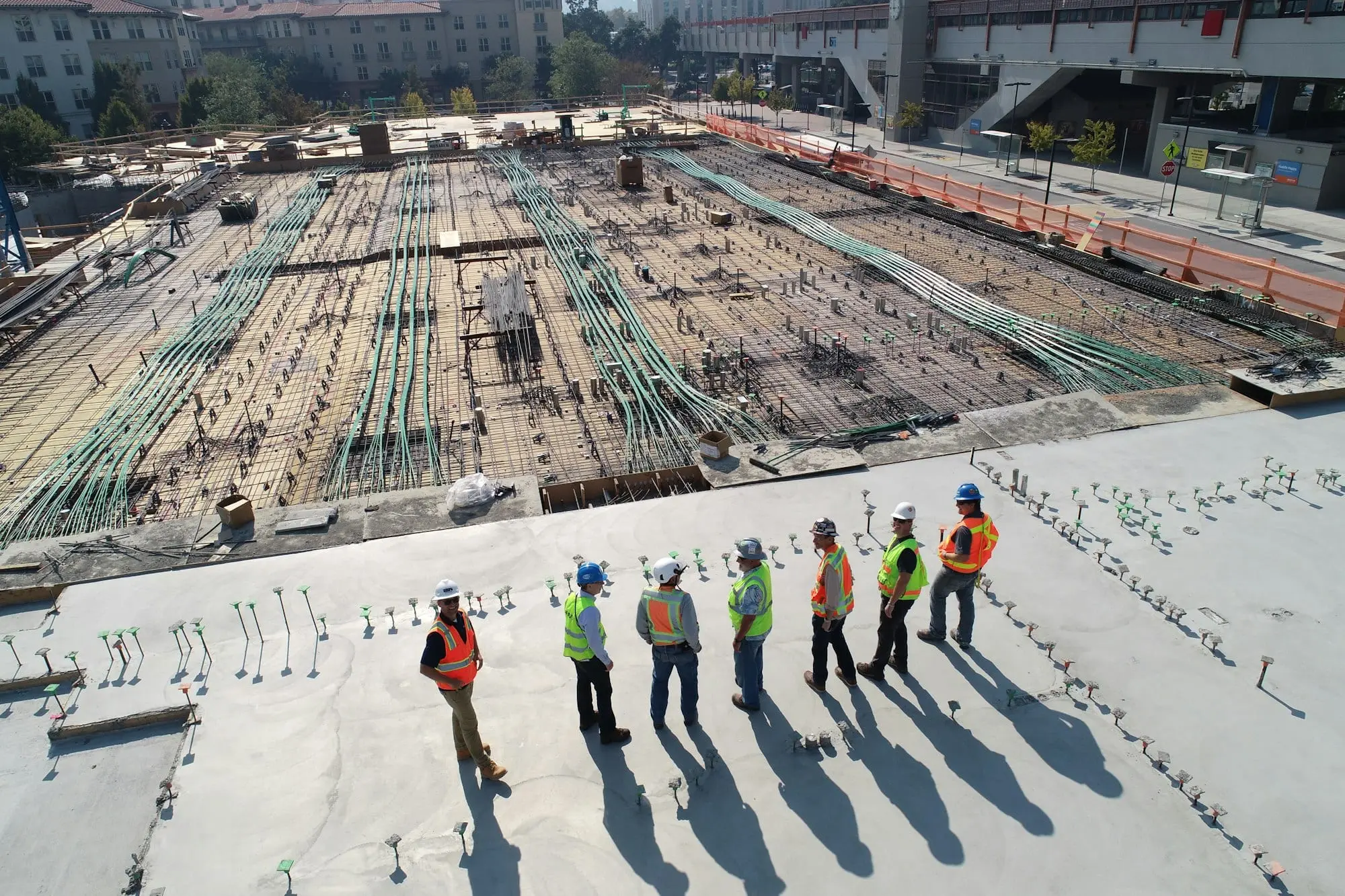 Equipe técnica reunida no canteiro de obras avaliando a laje antes da concretagem